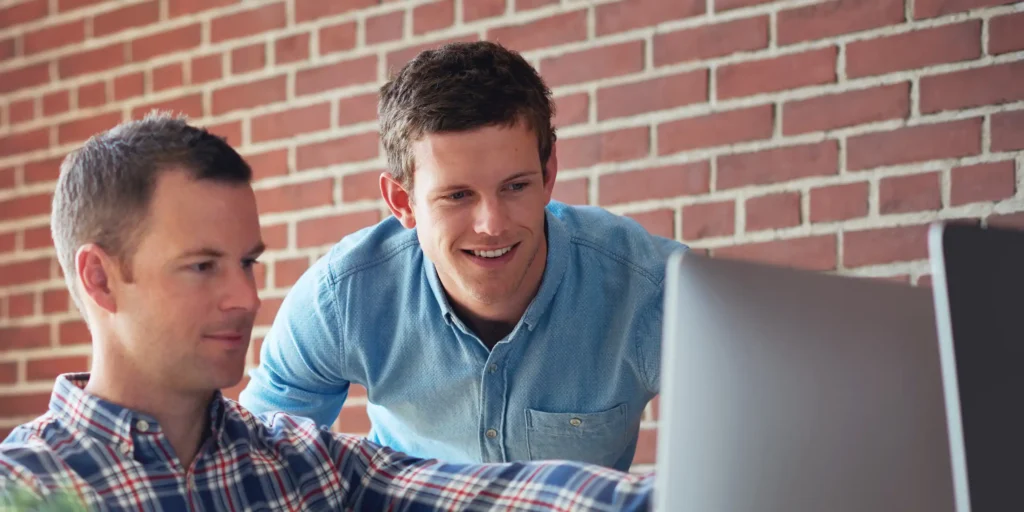 Team reviewing SEO and paid media performance on a desktop dashboard