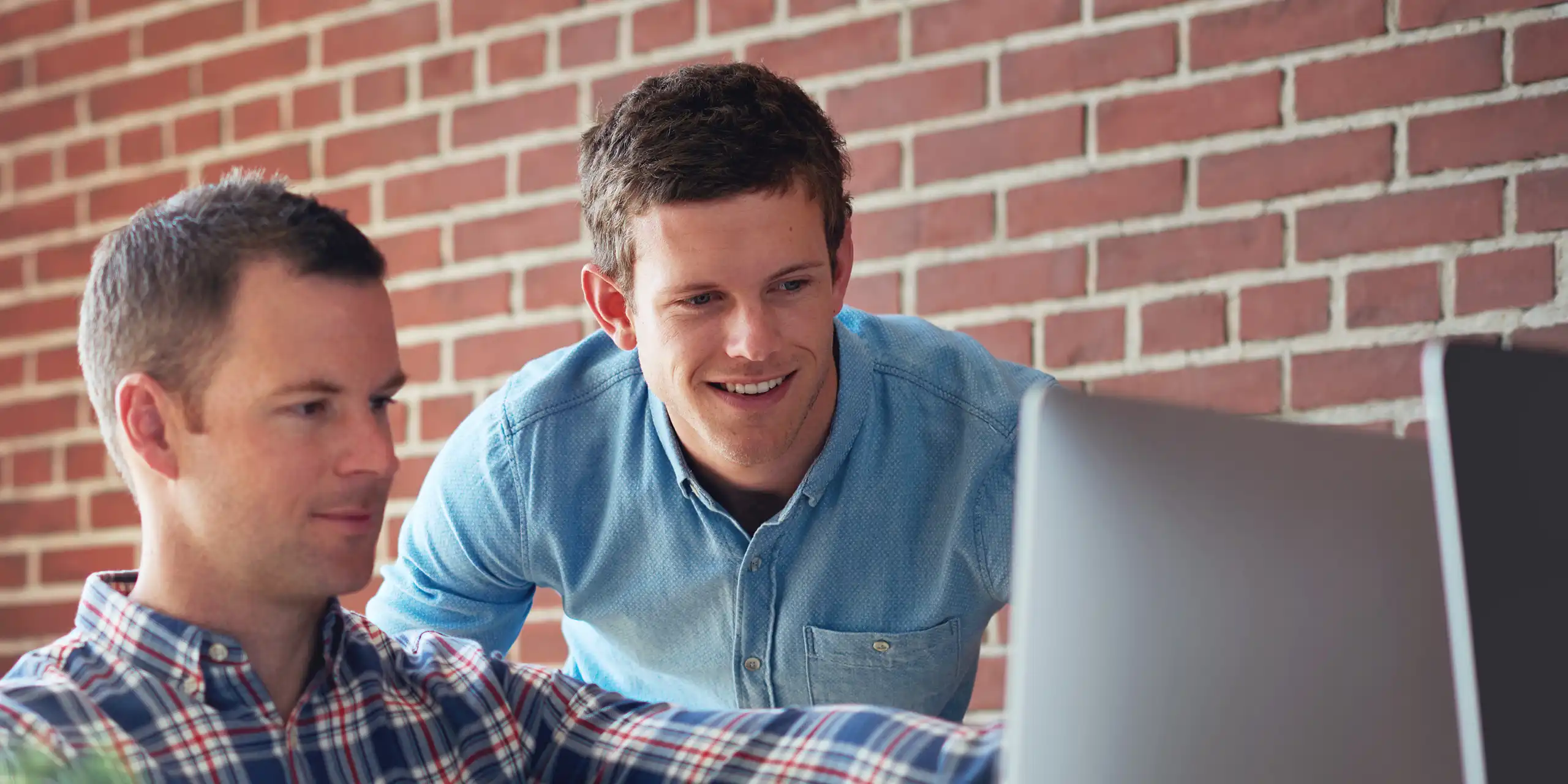 Team reviewing SEO and paid media performance on a desktop dashboard