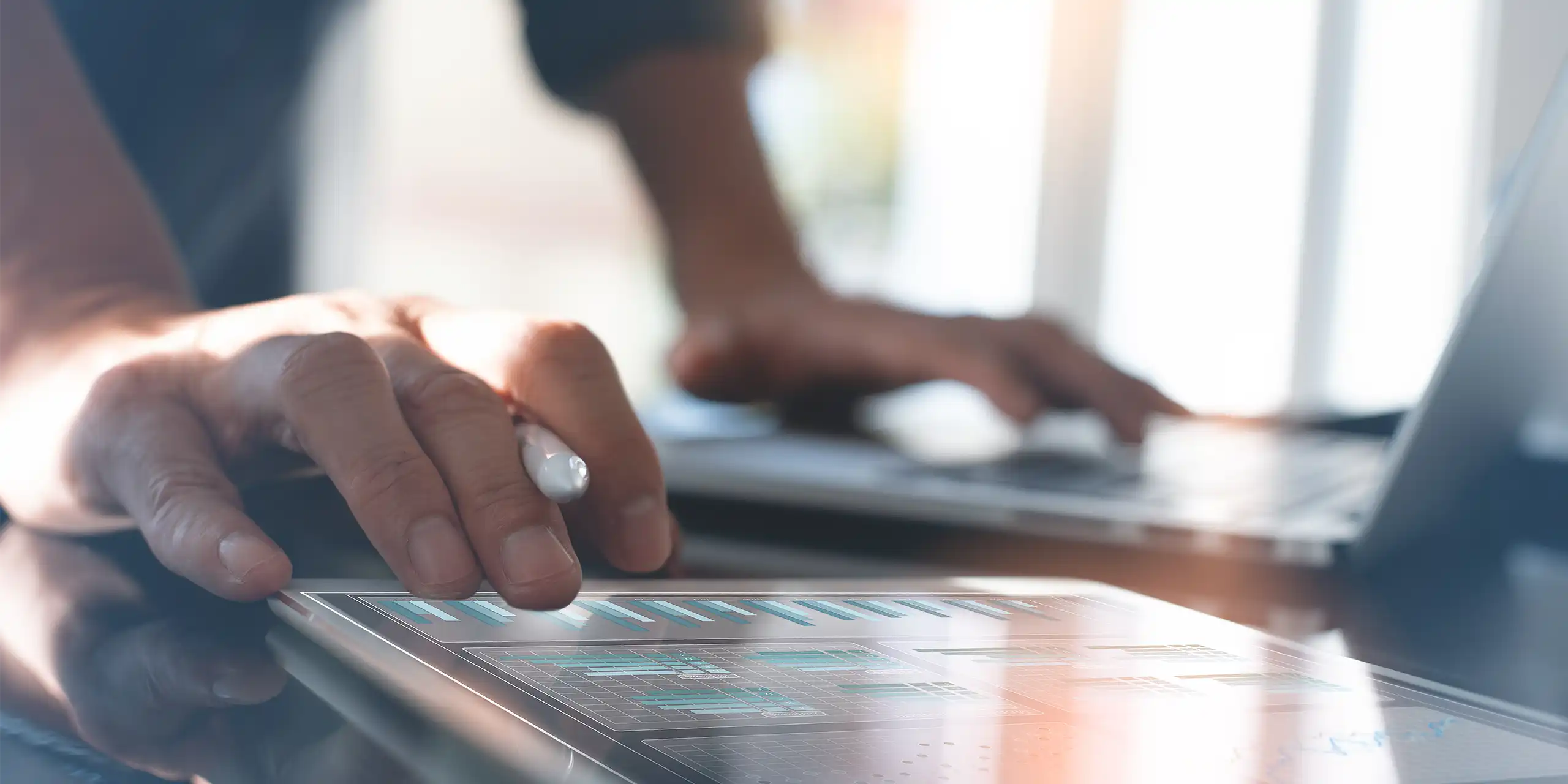 Hands reviewing performance analytics on a digital dashboard