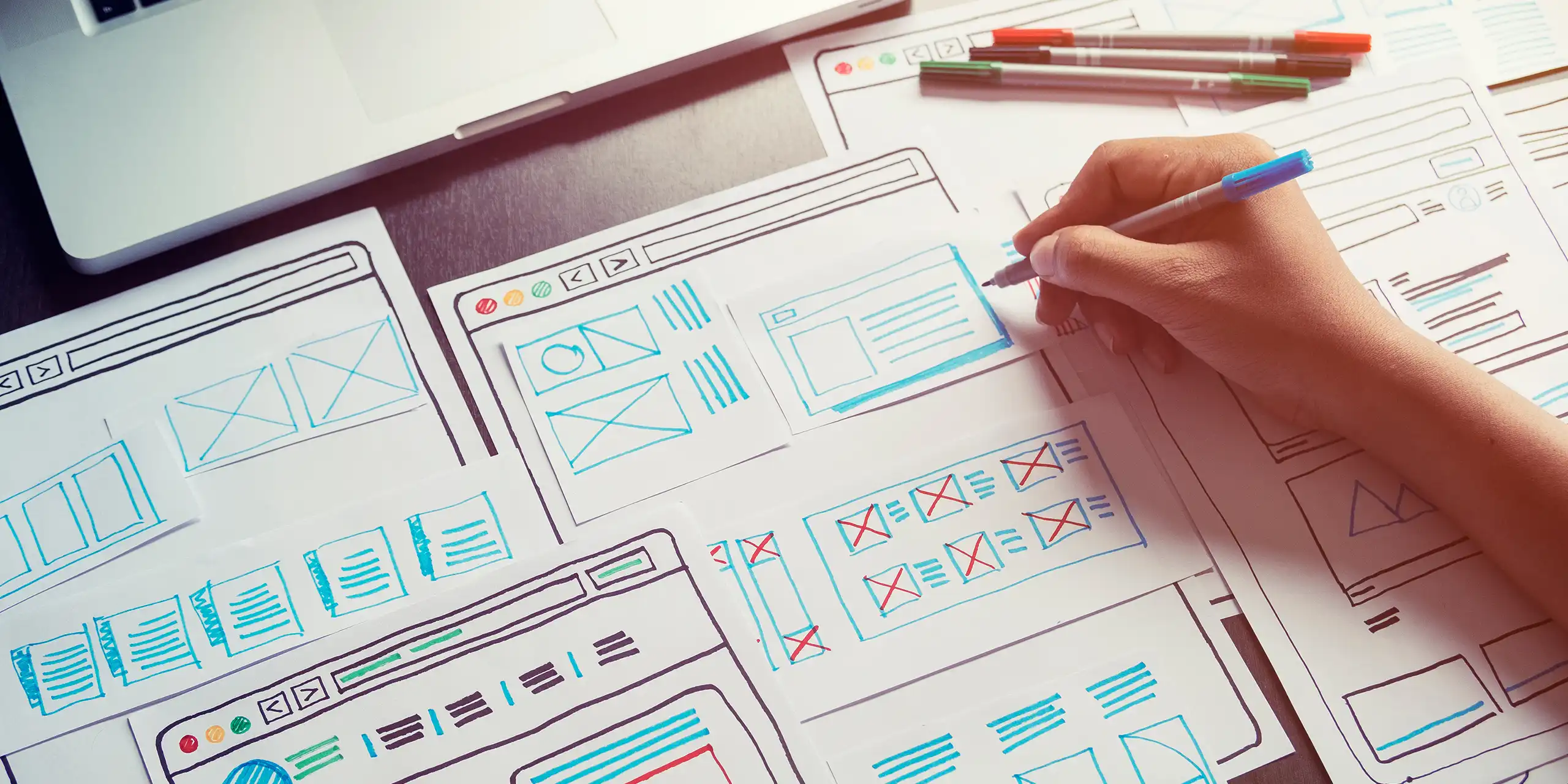 Hand sketching website wireframes and page layouts—UX planning for website design and development.