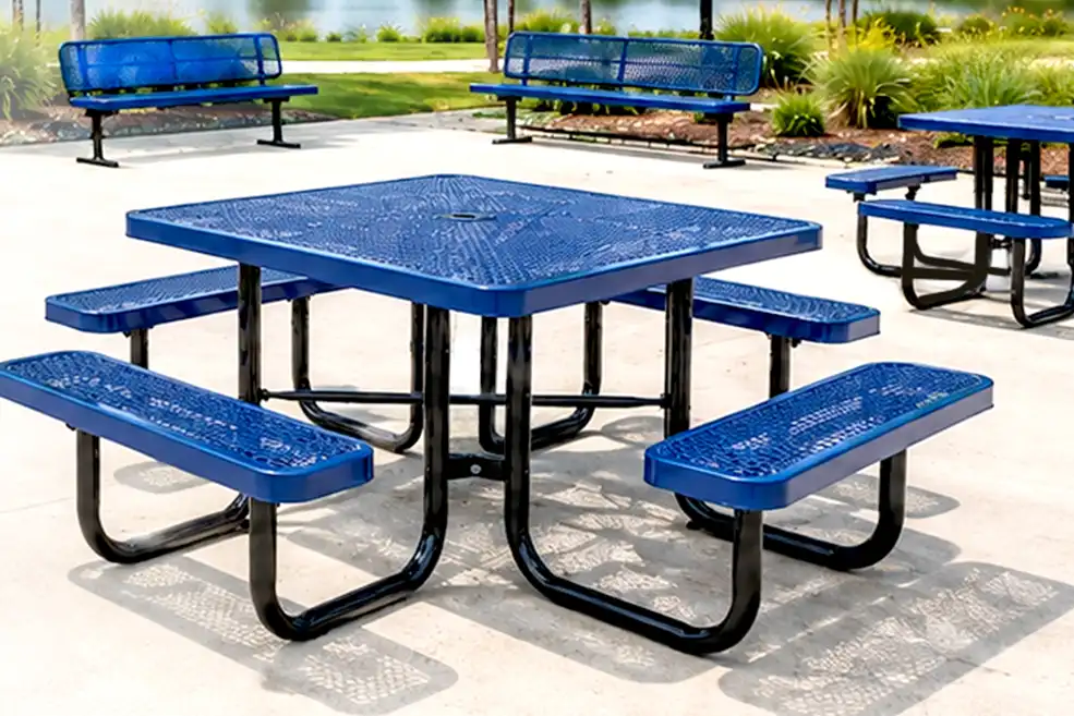 Blue commercial picnic table and benches in an outdoor recreation area